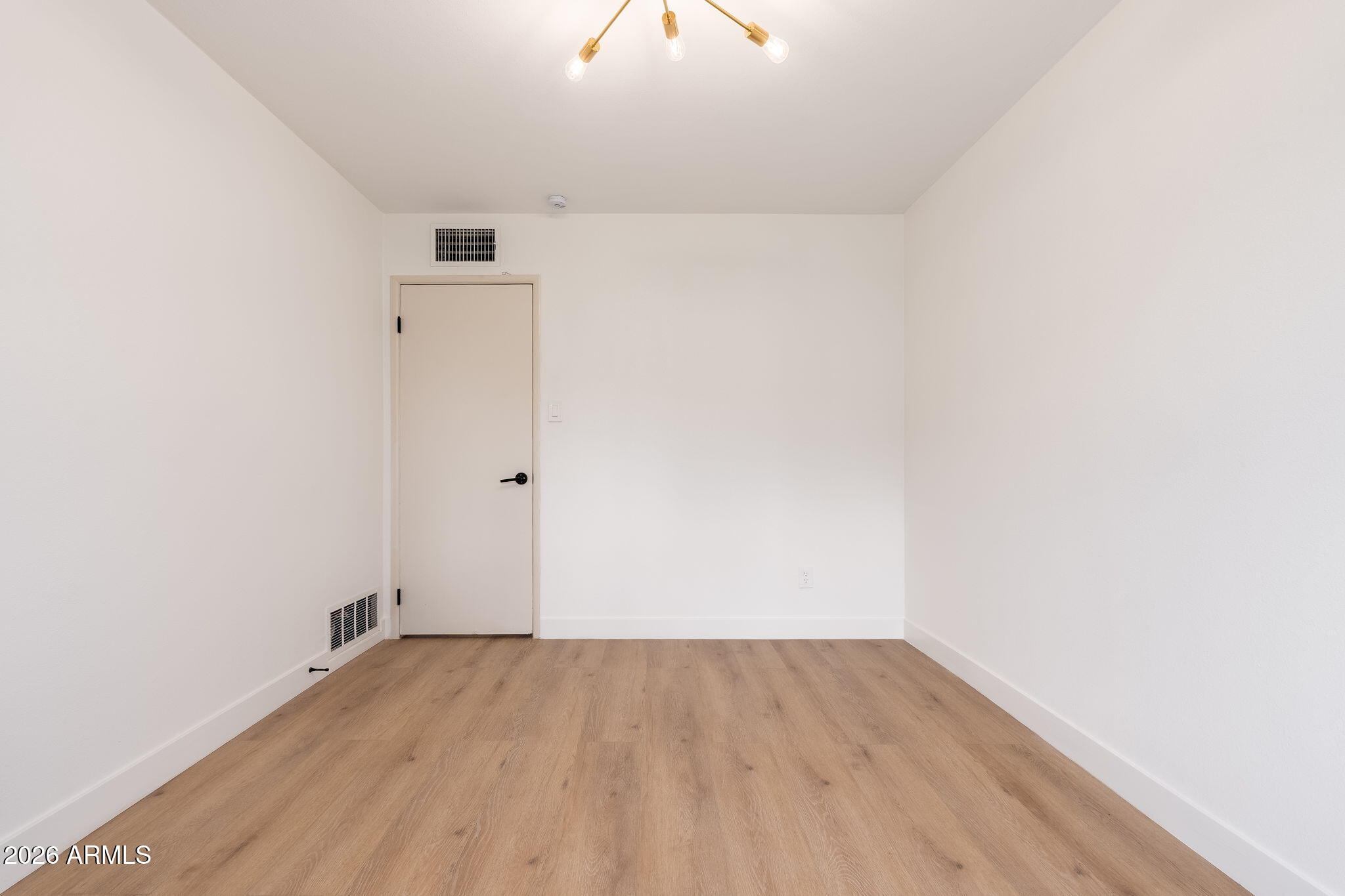 6134 North 9th Street Phoenix, AZ 85014 - Photo 21 of 36 a view of a room with wooden floor and a ceiling fan