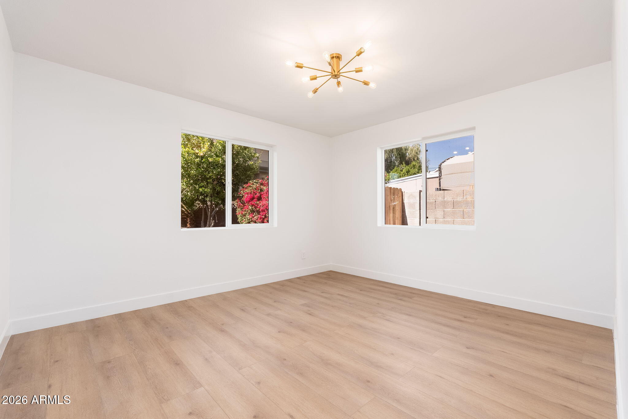 6134 North 9th Street Phoenix, AZ 85014 - Photo 22 of 36 an empty room with windows and fan