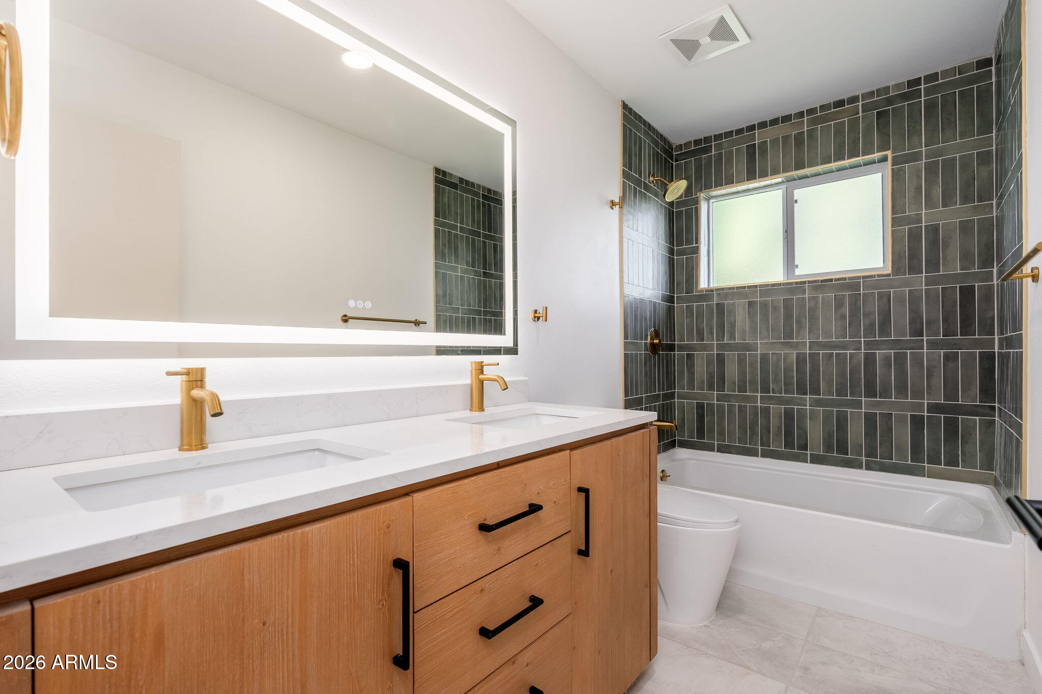 6134 North 9th Street Phoenix, AZ 85014 - Photo 24 of 36 a bathroom with a granite countertop sink mirror bathtub and shower