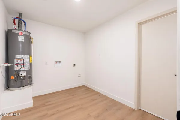 an empty room with wooden floor and gym equipment