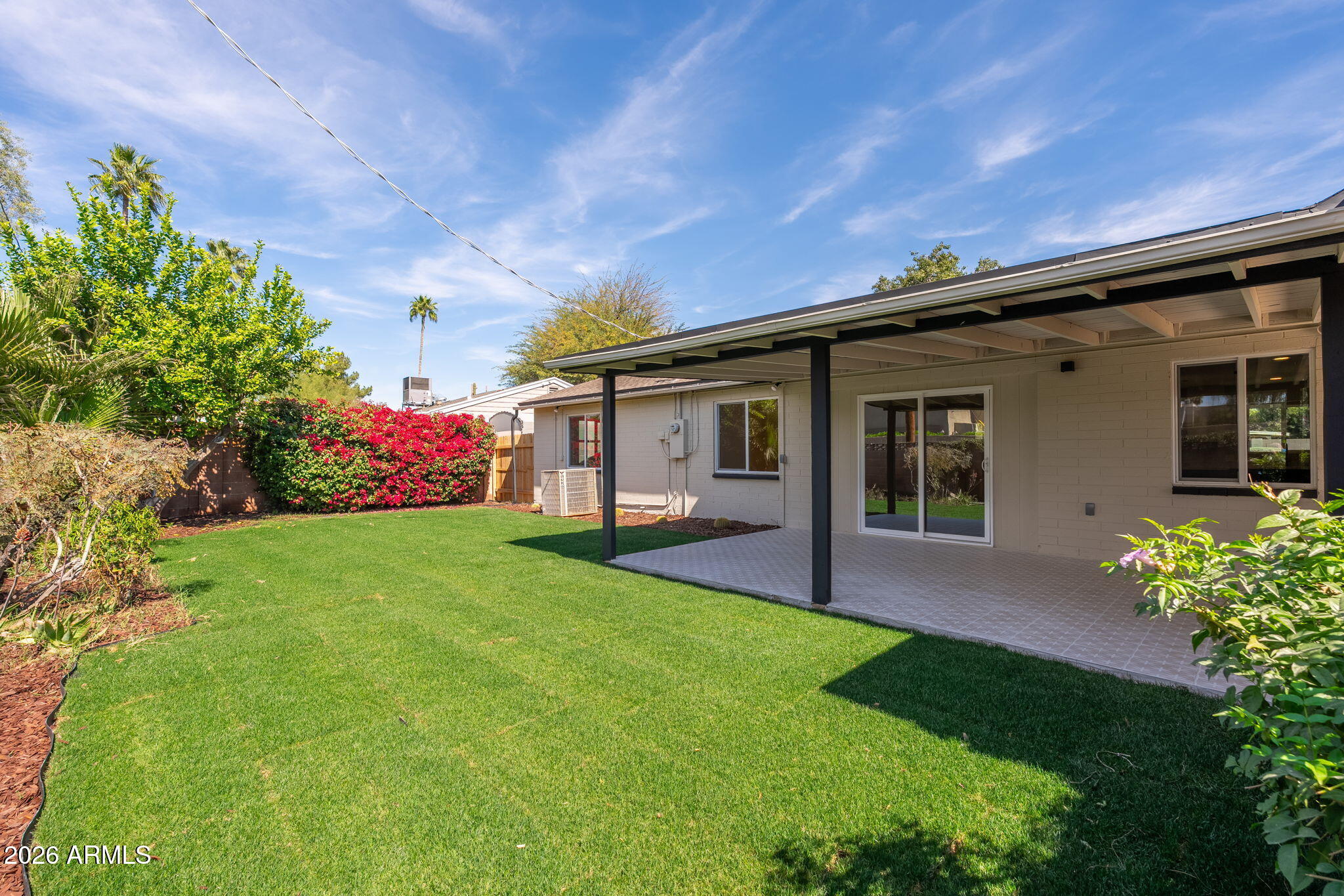 6134 North 9th Street Phoenix, AZ 85014 - Photo 29 of 36 a front view of a house with a garden and yard
