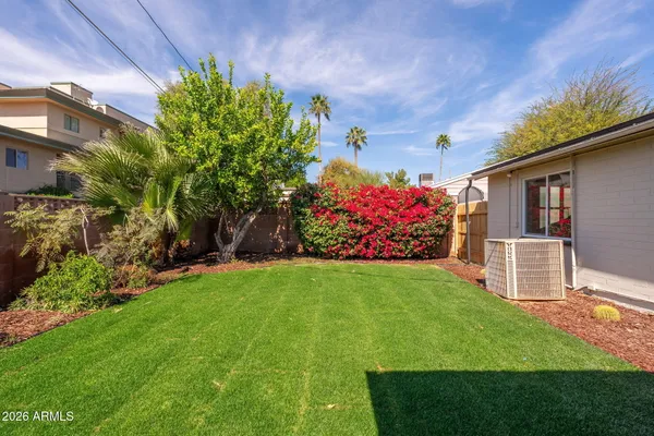 a view of a house with a yard and sitting area