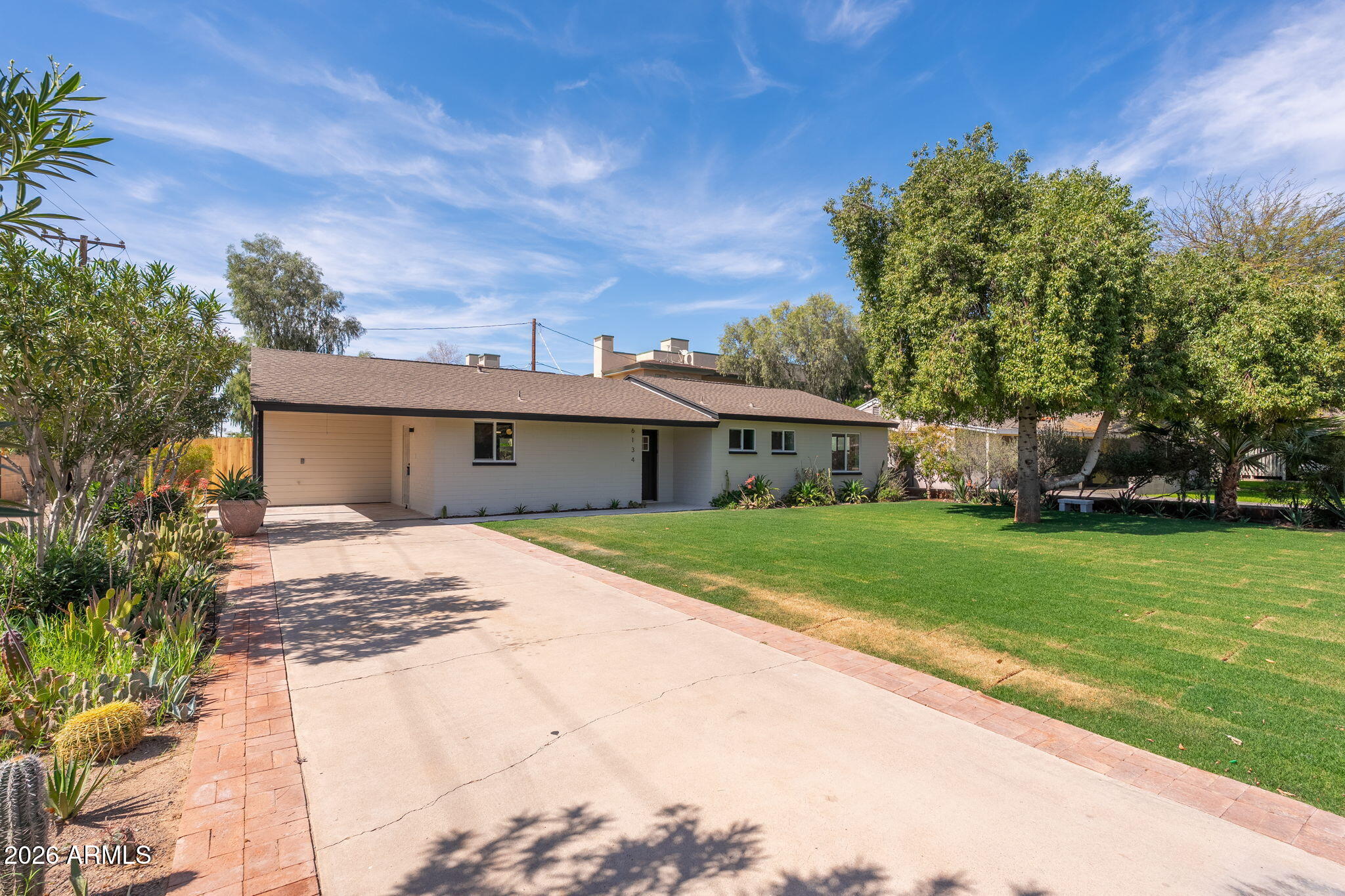 6134 North 9th Street Phoenix, AZ 85014 - Photo 35 of 36 a front view of house with yard and trees in the background