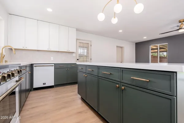 a kitchen with a sink stainless steel appliances and cabinets