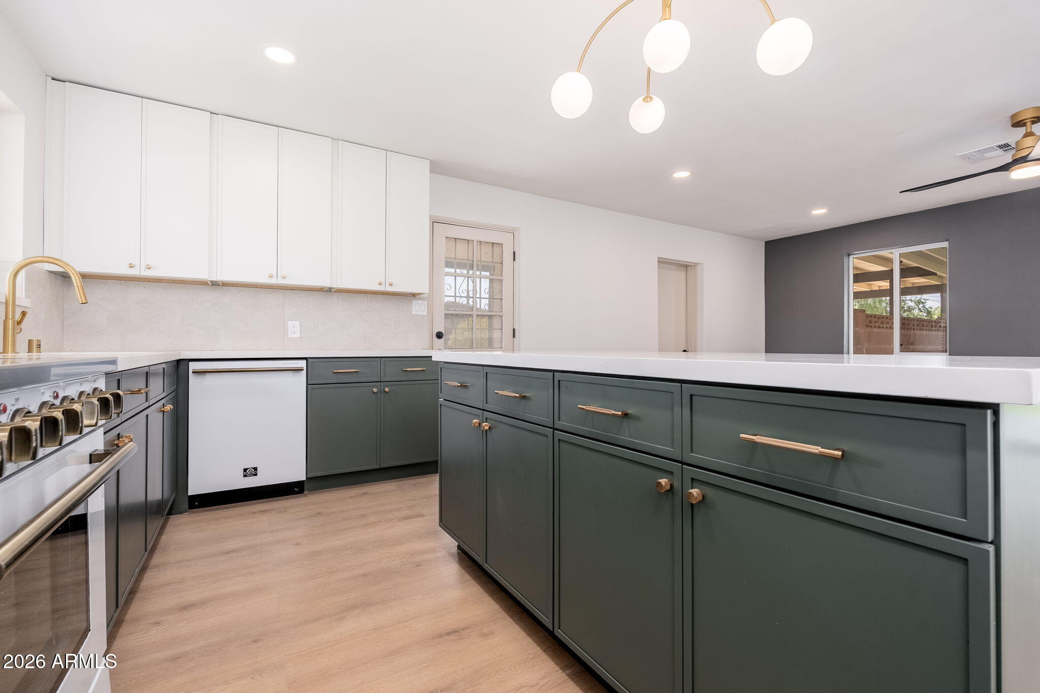 6134 North 9th Street Phoenix, AZ 85014 - Photo 4 of 36 a kitchen with a sink stainless steel appliances and cabinets