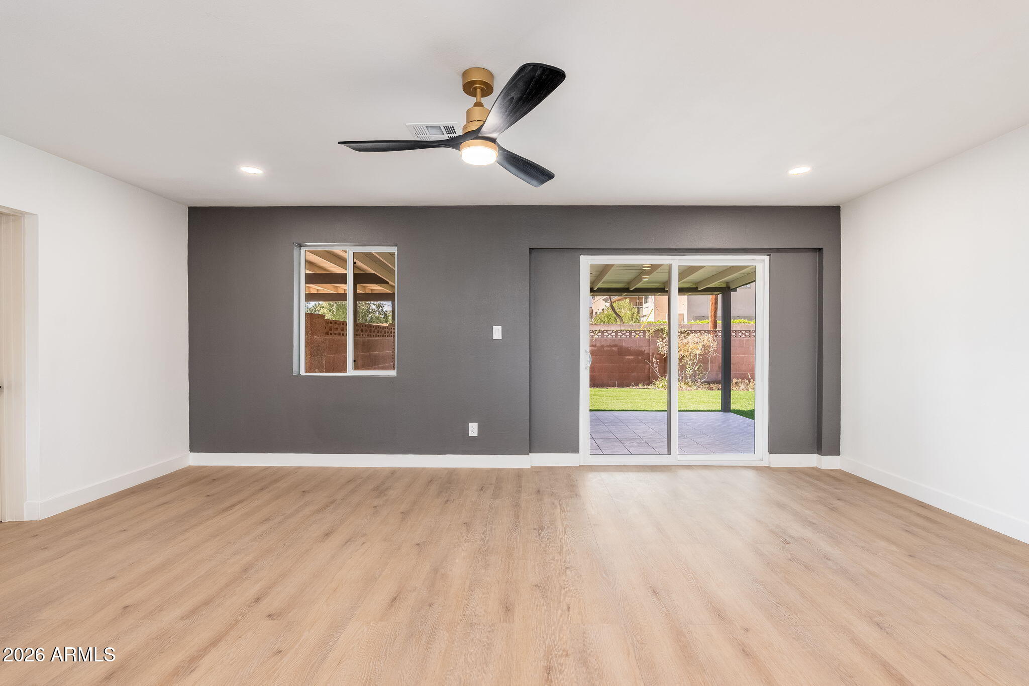 6134 North 9th Street Phoenix, AZ 85014 - Photo 10 of 36 a view of an empty room with a window and wooden floor