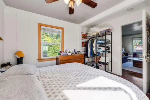 a bedroom with a large bed and a window