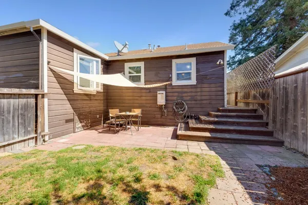 a view of a house with backyard and sitting area