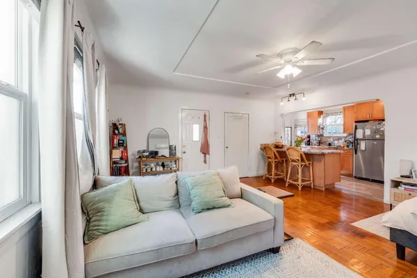 a living room with furniture and kitchen view
