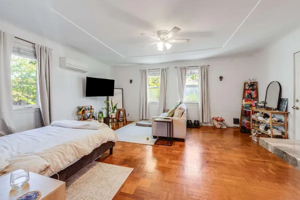 a bedroom with furniture and a flat screen tv