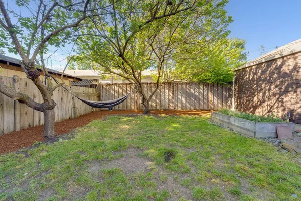 a view of a house with a yard and sitting area