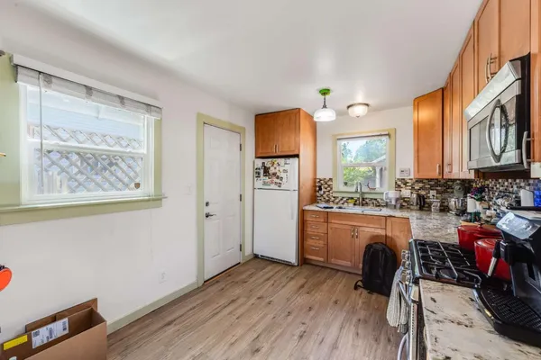 a kitchen with sink cabinets and wooden floor