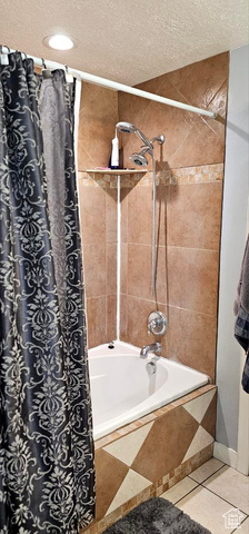 2269 Clear Creek Road Nibley, UT 84321 - Photo 26 of 27 Full bathroom featuring tiled shower / bath, a textured ceiling, and tile patterned floors