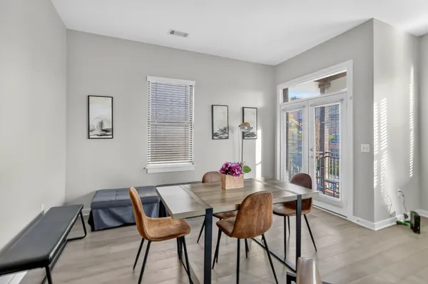 a dining room with furniture and window