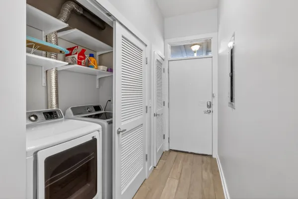 a view of a storage and utility room with washer and dryer