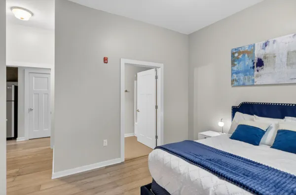 a bedroom with a bed and wooden floor