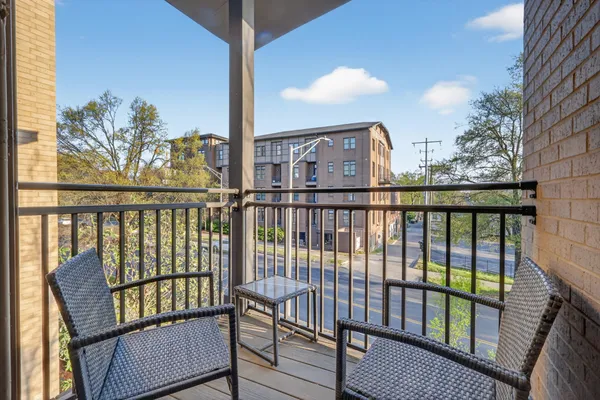 a view of a balcony with wooden floor