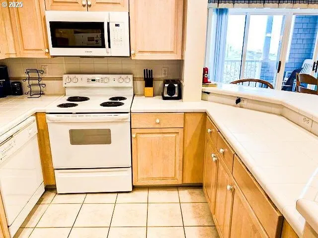 a kitchen with a sink a stove and a microwave