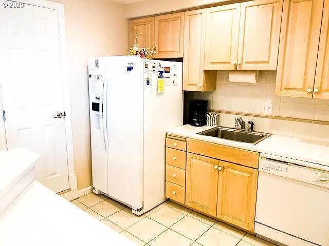 a white refrigerator freezer sitting in a kitchen