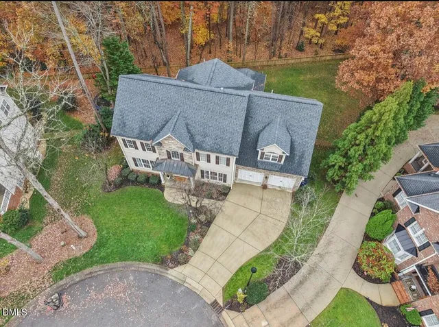 a front view of a house with a garden and garage