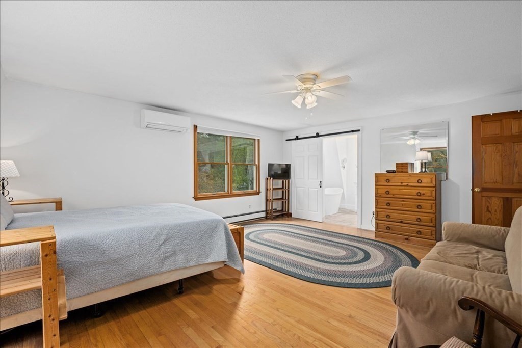 29 Gay Road Brookfield, MA 01506 - Photo 19 of 42 a bedroom with a bed and a chandelier