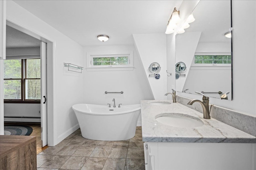 29 Gay Road Brookfield, MA 01506 - Photo 20 of 42 a spacious bathroom with a double vanity sink a mirror and a bathtub