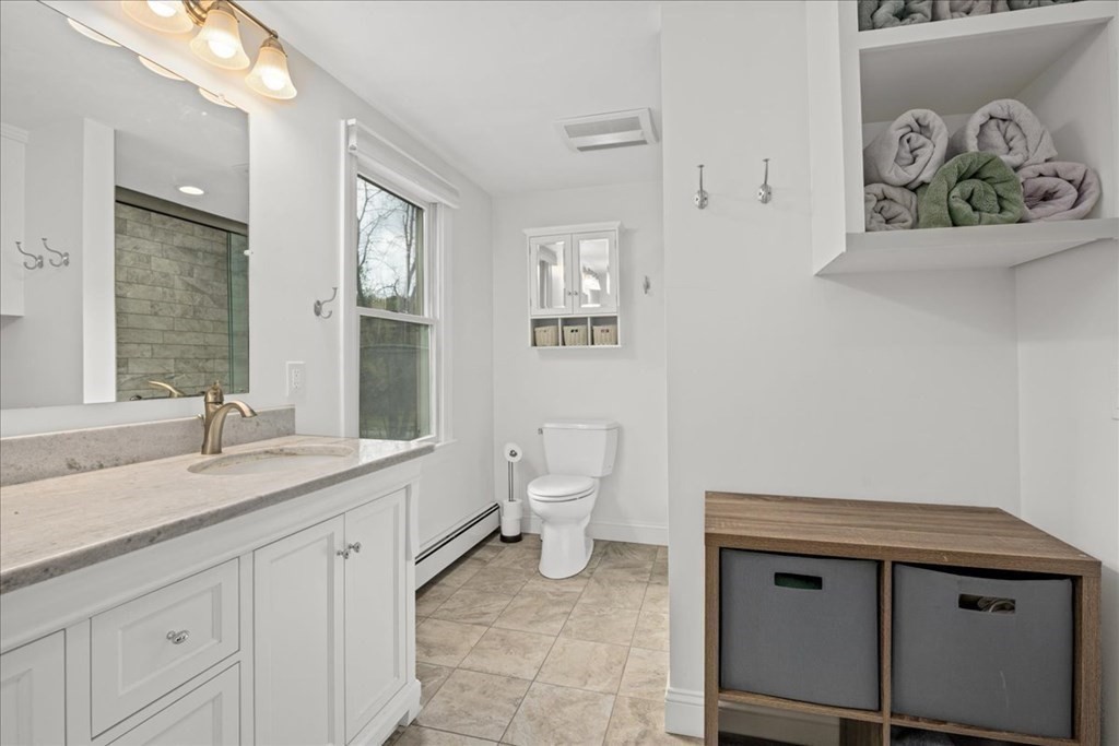 29 Gay Road Brookfield, MA 01506 - Photo 22 of 42 a bathroom with a granite countertop sink a toilet and a mirror