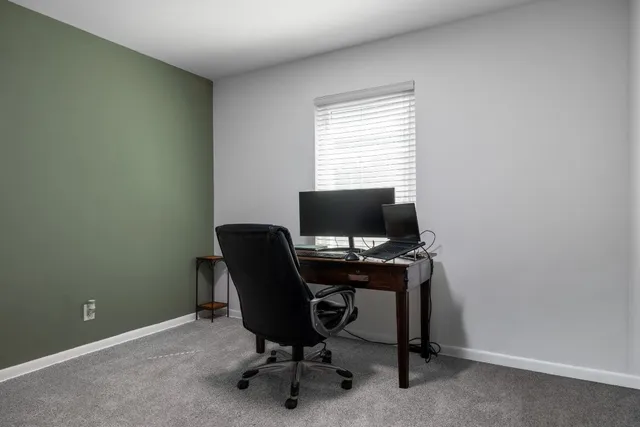 a bathroom with a granite countertop sink a toilet and a mirror