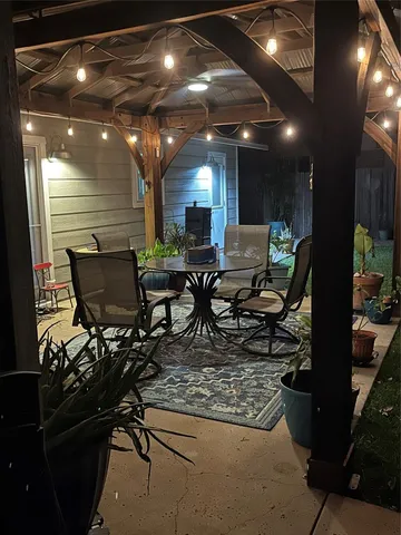 a view of a house with backyard porch and sitting area