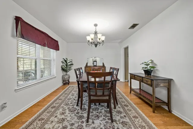 a dining room with furniture a rug and a chandelier