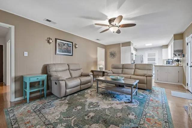 a living room with furniture and a chandelier