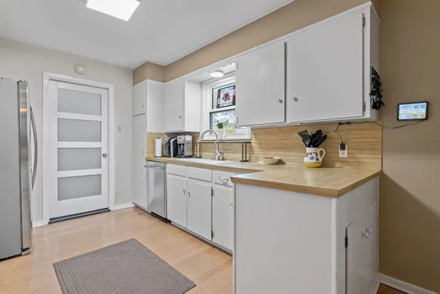 a kitchen with stainless steel appliances granite countertop a sink stove and cabinets