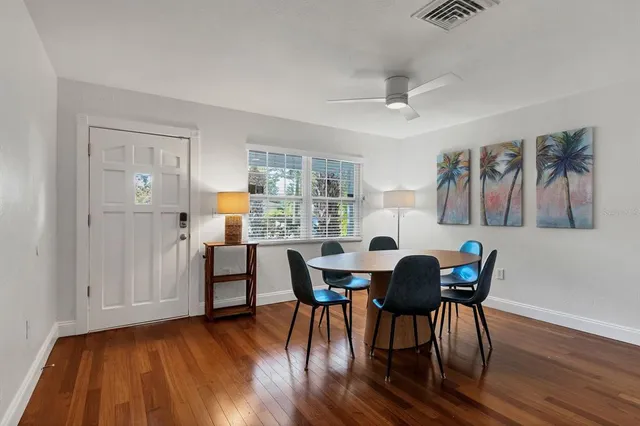 a view of a dining room with furniture and wooden floor