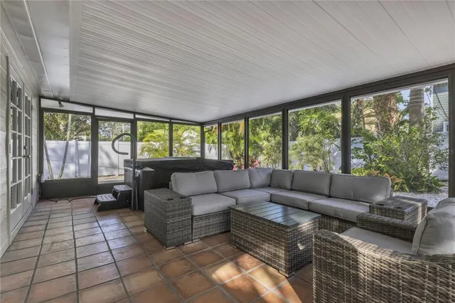 a living room with furniture and large windows