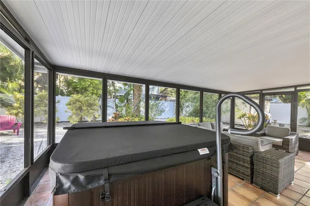 a bedroom with a bed and a flat tv screen on dresser