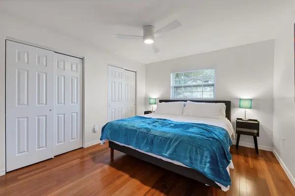 a bedroom with a bed window and a table