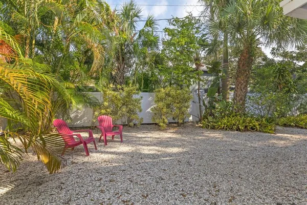 a view of a yard with table and chairs and a fire pit