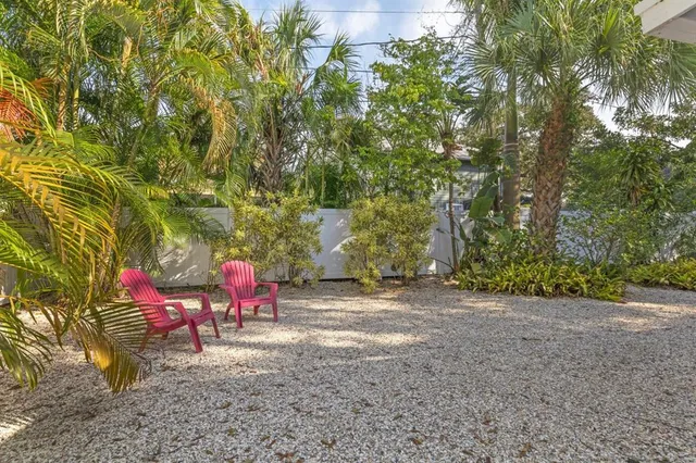 a view of a yard with table and chairs and a fire pit