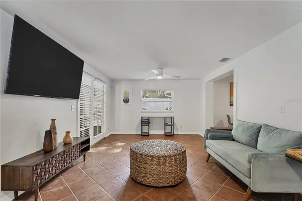 a living room with furniture a flat screen tv and a fireplace