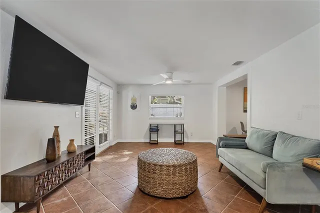 a living room with furniture a flat screen tv and a fireplace