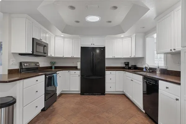 a kitchen with a refrigerator stove and microwave