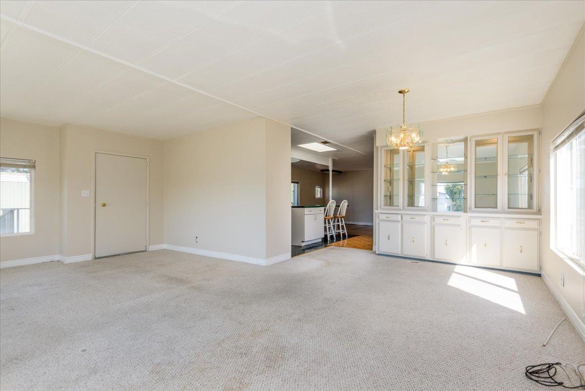 52 Oceanview Avenue, Unit 52 Half Moon Bay, CA 94019 - Photo 4 of 15 an empty room with fireplace and windows