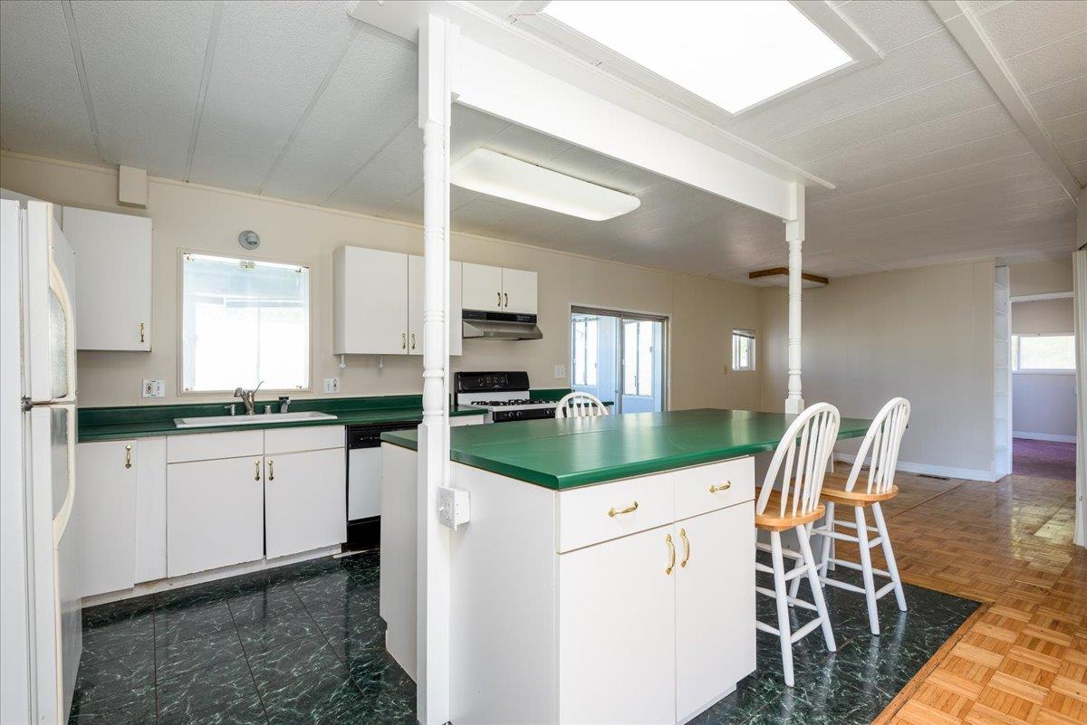52 Oceanview Avenue, Unit 52 Half Moon Bay, CA 94019 - Photo 5 of 15 a kitchen with white cabinets and white appliances