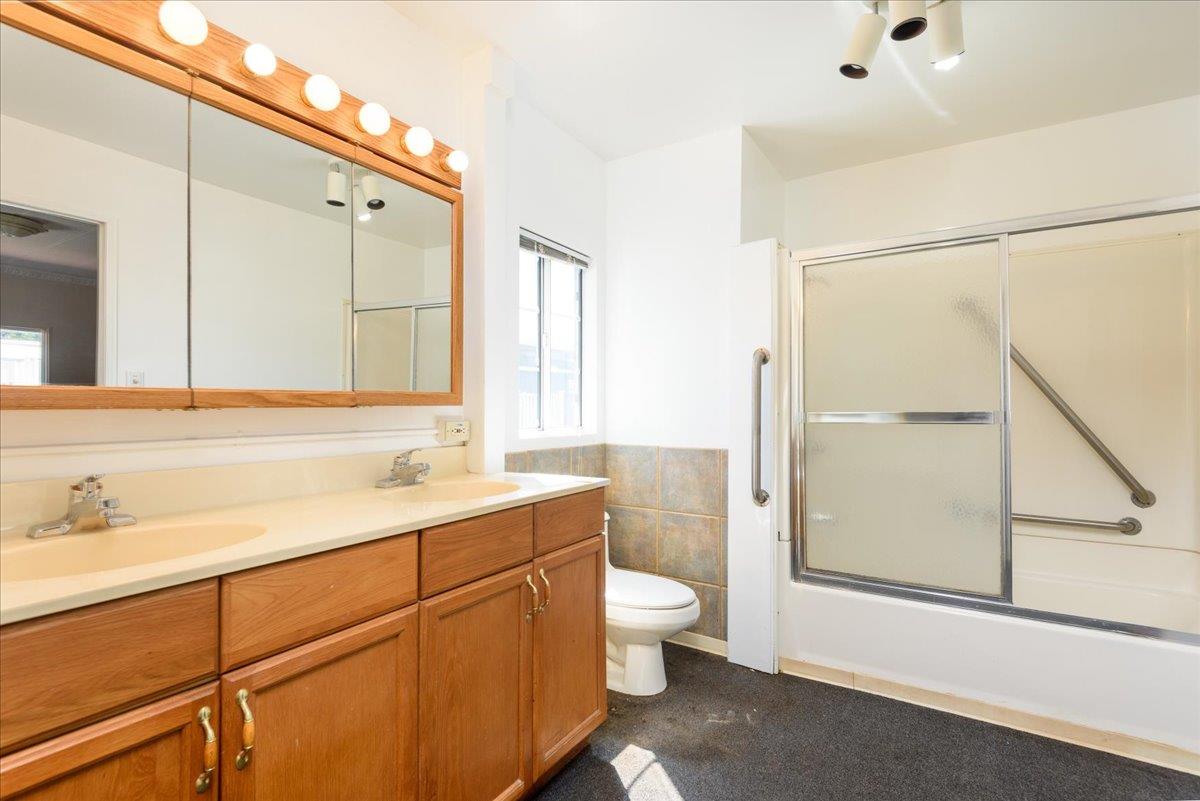 52 Oceanview Avenue, Unit 52 Half Moon Bay, CA 94019 - Photo 10 of 15 a bathroom with a double vanity sink toilet mirror and bathtub