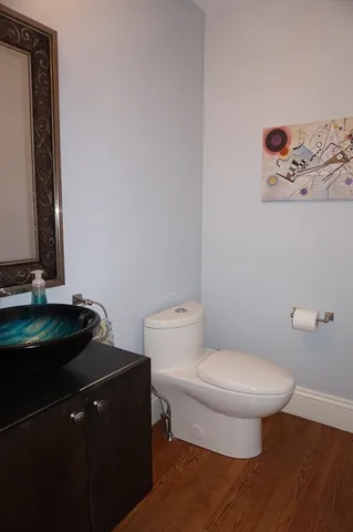 a bathroom with a toilet and a mirror