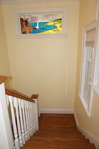 a view of staircase with wooden floor