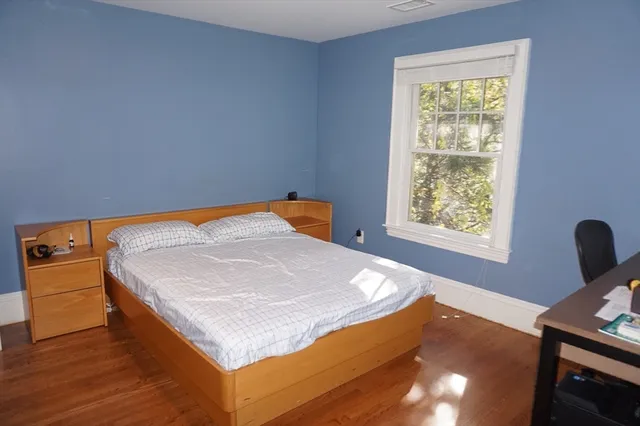 a bedroom with a bed and window