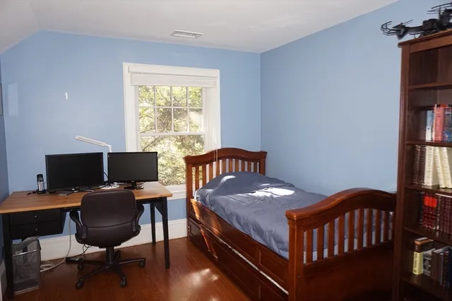 a bedroom with a bed and a desk