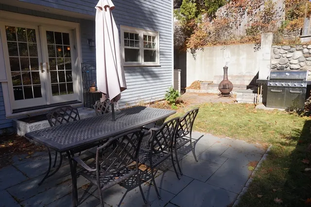 a view of a patio with table and chairs and potted plants
