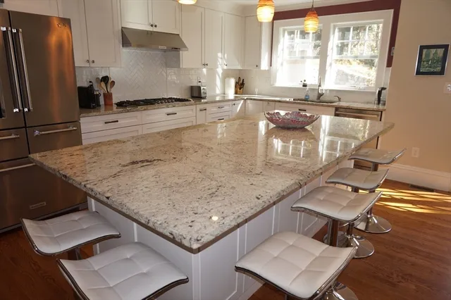 a kitchen with a sink a counter top space and stainless steel appliances